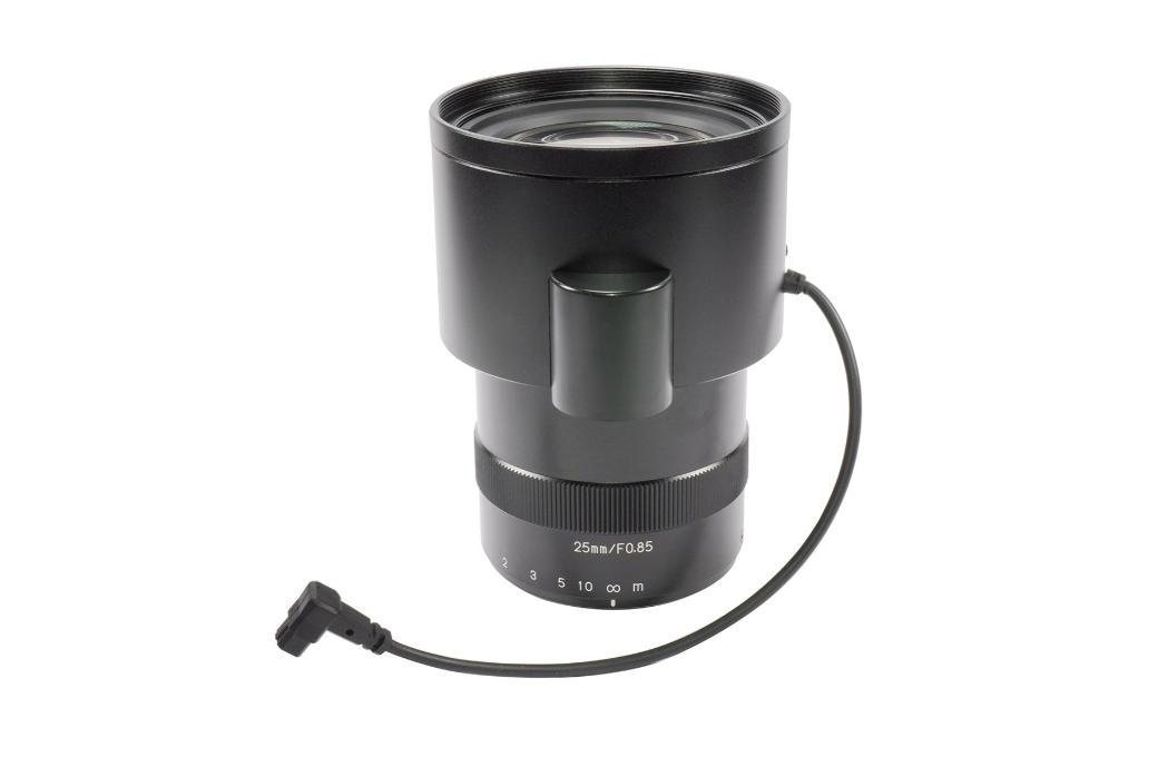 Black camera lens with a cable on a white background