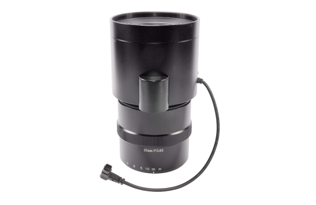 Black camera lens with a cable on a white background