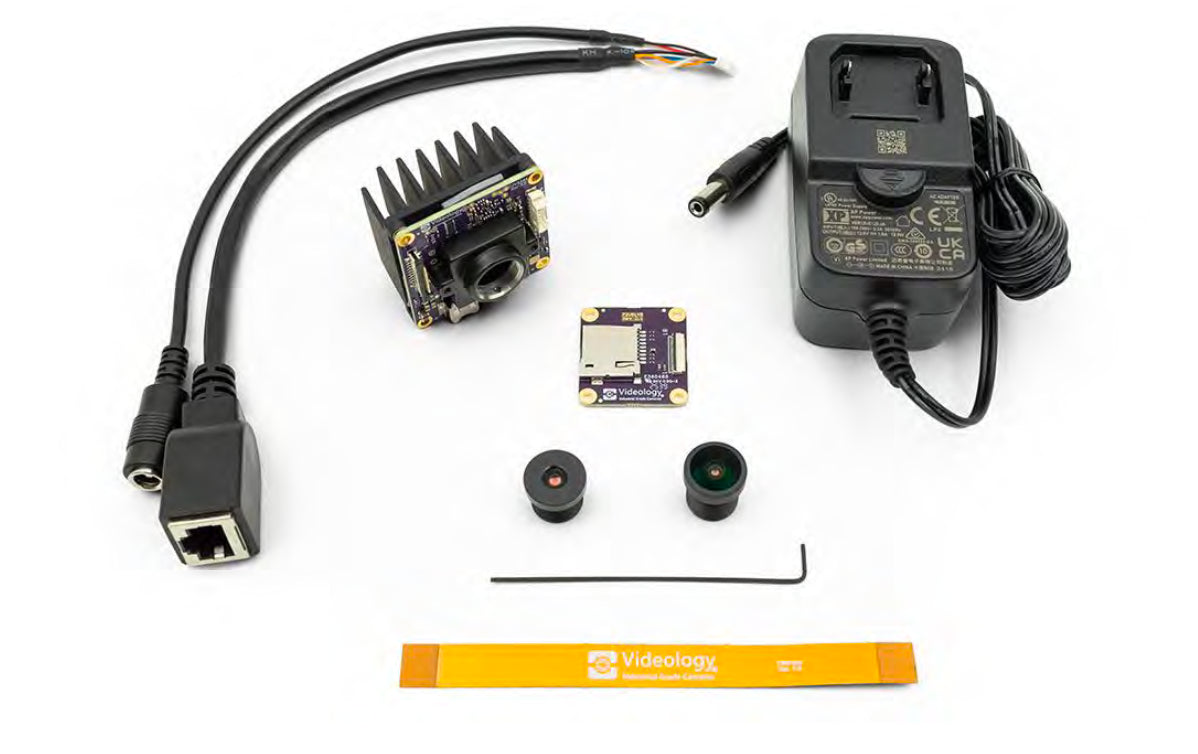 Collection of lenses cables and a power adapter with 801-IP-678 camera on a white background